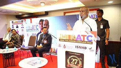 Image shows Telangana Health Minister Damodar Raja Narasimha speaking at the Asian Thalassemia Conclave at Kamala Hospital in Hyderabad