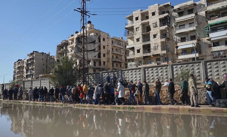 Civilians evacuate an area of the Sheikh Maqsoud neighborhood, where clashes between government forces and Kurdish fighters have been taking place in the northern city of Aleppo, Syria on Saturday. (AP Photo/Omar Albam)