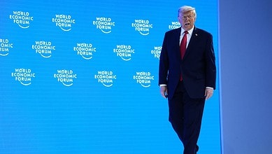President Donald Trump arrives on stage to address the audience during the Annual Meeting of the World Economic Forum in Davos, Switzerland, Wednesday (AP)