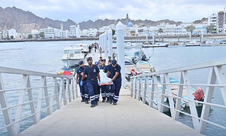 Royal Oman Police carry a dead body after boat capsizes