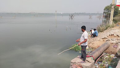 Anglers wait patiently to catch a fish or two at the Bibinagar Lake