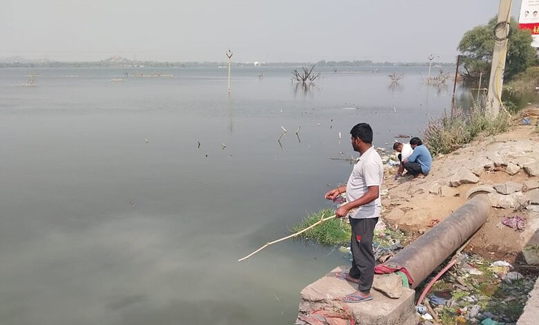 Anglers wait patiently to catch a fish or two at the Bibinagar Lake