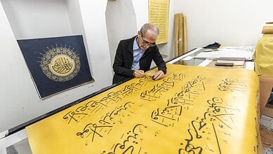 Iraqi Calligrapher Ali Zaman works on the hand written Quran