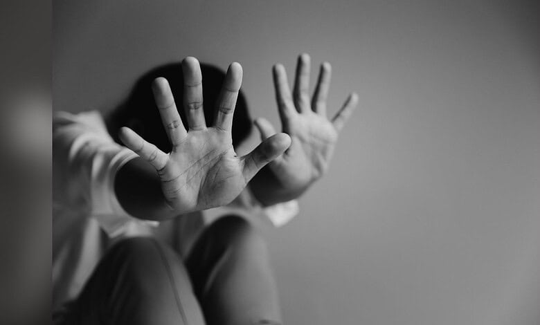 Image showing a child blocking their face with their hands
