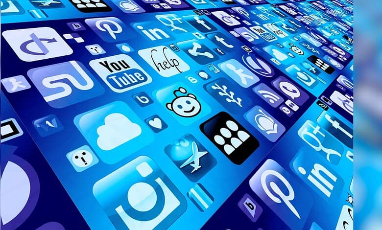 Image shows A collection of blue-tinted social media and app icons displayed in a perspective grid layout on a digital screen.