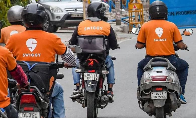 Image showing Swiggy delivery agents on bikes