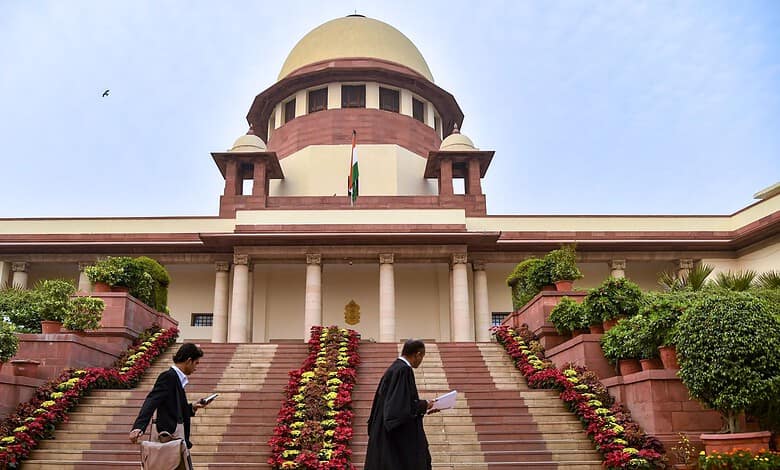 View of the Supreme Court of India with steps and surrounding greenery.