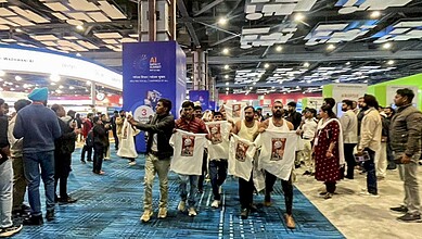 Protest by Youth Congress workers holding banners during a shirtless demonstration at a public event.
