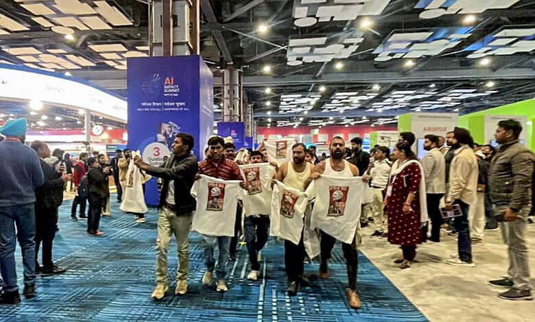 Protest by Youth Congress workers holding banners during a shirtless demonstration at a public event.