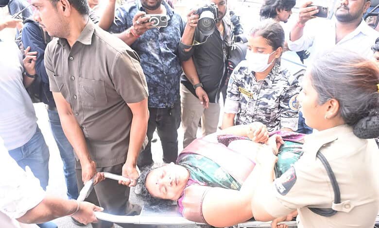 The image shows an ASHA worker who fell unconscious during a protest in Koti, being shifted to a hospital on February 23, 2026.