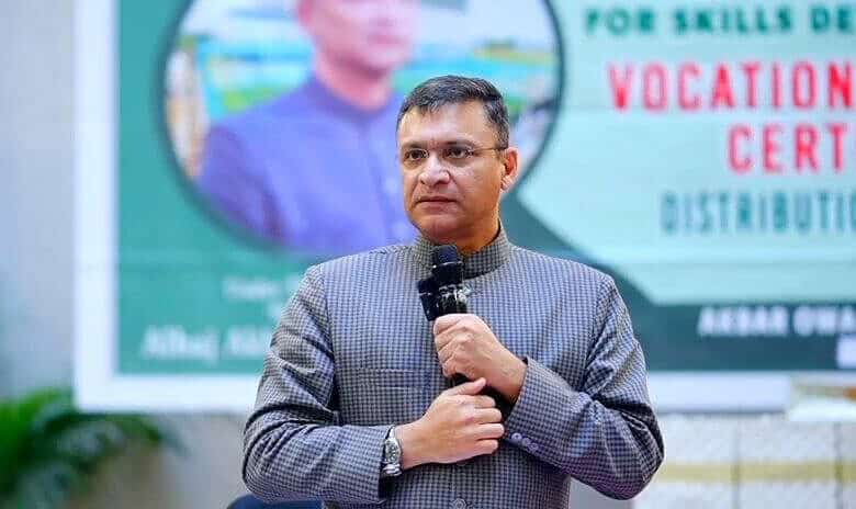 Akbaruddin Owaisi speaking at an event, comparing Revanth Reddy to Yogi Adityanath over demolition remark.