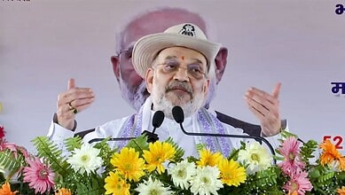 Amit Shah speaking at a political rally in West Bengal, emphasizing BJP's victory and anti-infiltration s.