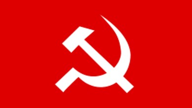 Protesters holding flags and banners during a political rally in India.