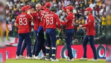 England cricket players celebrating after a wicket in T20 World Cup match.