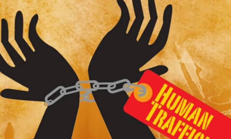 Human trafficking awareness illustration with chained hands and warning tag.