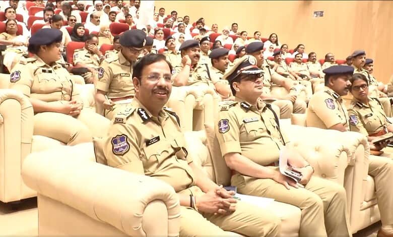 Police officers attending a formal event in uniform at a conference or ceremony.