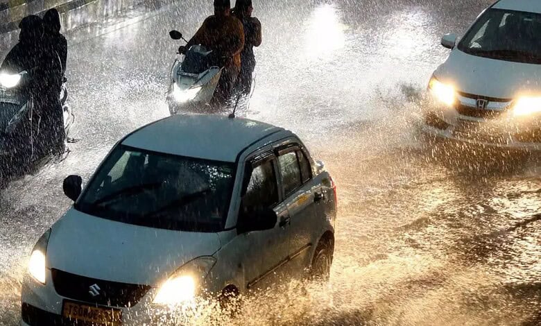 Flooded Hyderabad streets during unseasonal rains with cars and motorbikes in water.