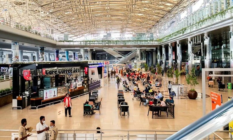 Modern Hyderabad airport terminal with passengers and cafes, showcasing Telangana's growing connectivity.