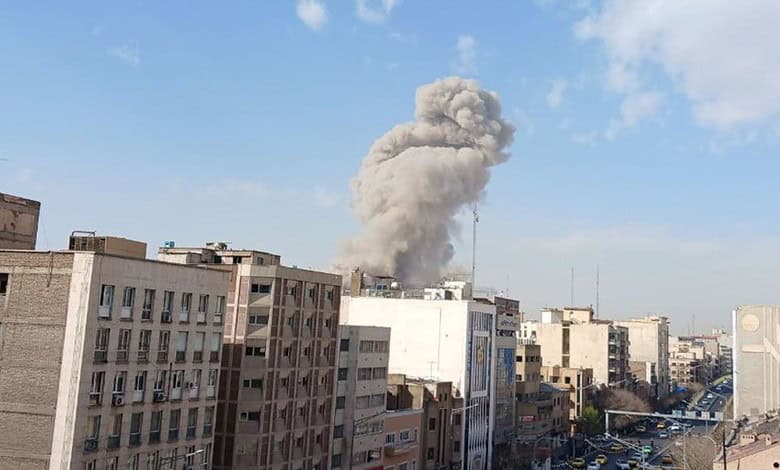 Explosion and smoke rising over Tehran city skyline during pre-emptive strikes.
