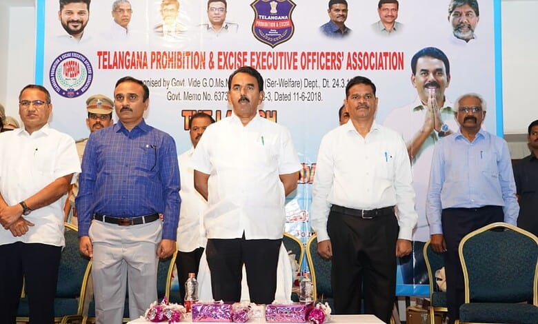 Officials at Telangana Prohibition & Excise event discussing arms provision for excise officers.