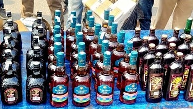 Assorted bottled drinks at a market stall, including soft drinks and energy beverages.