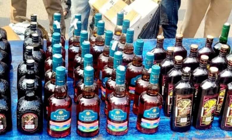Assorted bottled drinks at a market stall, including soft drinks and energy beverages.