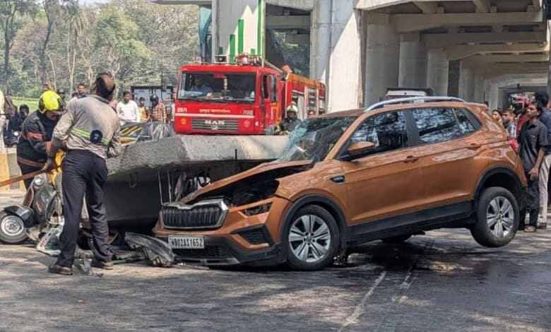 Accident scene with damaged car and emergency responders in Mumbai.