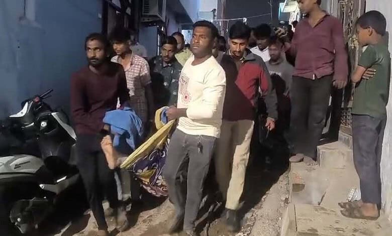 People gather at the site of a house collapse in Hyderabad, with four injured victims receiving assi.
