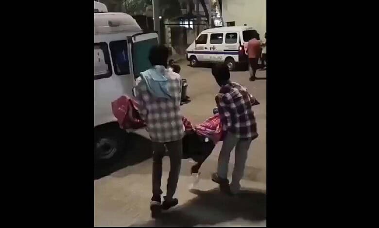 Family members carry dead body of a woman in Telangana after being denied a stretcher