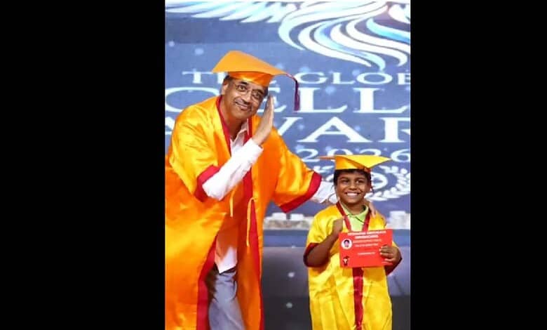 Principal in Pushpa pose at convocation, dressed in academic gown, celebrating achievement.
