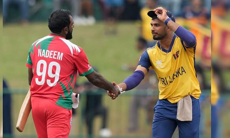 Sri Lanka's captain Dasun Shanaka, right, and Oman's Mohammad Nadeem shake hands after Sri Lanka won the T20 World Cup cricket match against Oman in Pallekele