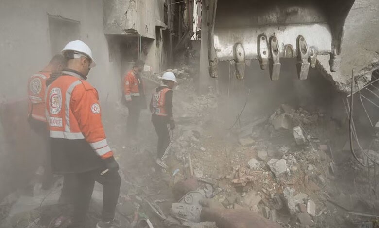 Authorities inspect the site in Gaza after an Israeli air strike killed three people