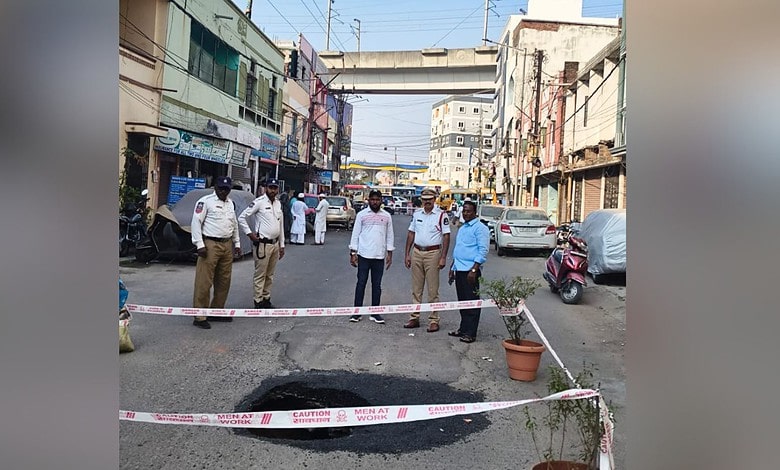 Police officers inspecting a street scene with caution tape in an urban area.