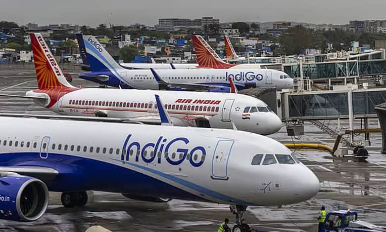 Air India, IndiGo, SpiceJet aircraft parked at airport with terminal in background.