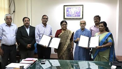 Group of officials holding signed documents during the partnership ceremony.