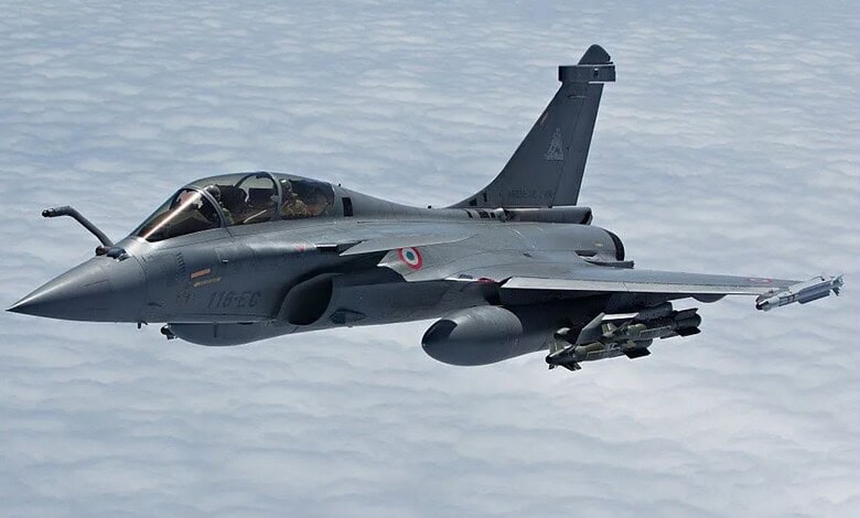 Rafale fighter jet flying over clouds, showcasing India's military strength and defence capabilities.