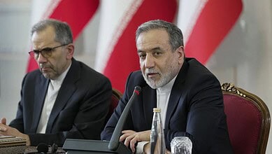 Iranian officials at a conference table during nuclear negotiations in Geneva.