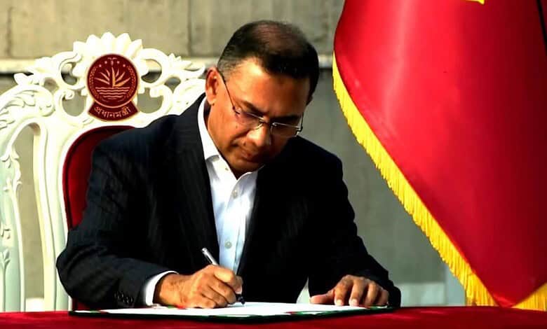 Tarique Rahman signing official documents during his swearing-in as Bangladesh's new Prime Minister.