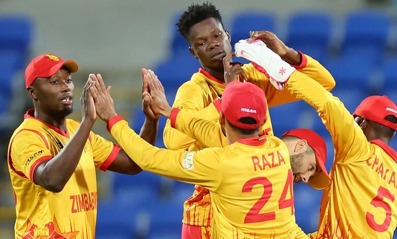 Zimbabwe cricket team celebrating after a match, players in yellow and red uniforms.