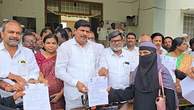 Telangana government hands over cheques and mopeds to minority beneficiaries.