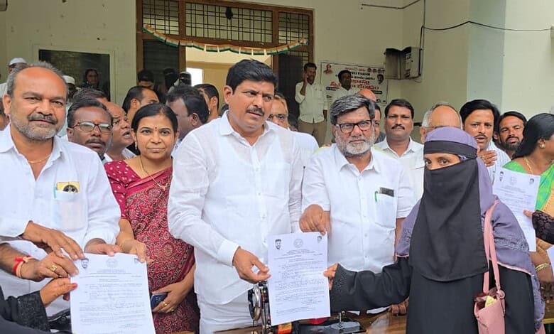 Telangana government hands over cheques and mopeds to minority beneficiaries.