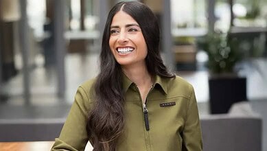 Asha Sharma, Indian-origin CEO of Microsoft Gaming, smiling in a modern office setting.