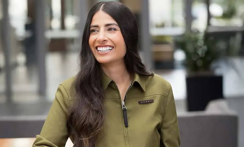 Asha Sharma, Indian-origin CEO of Microsoft Gaming, smiling in a modern office setting.