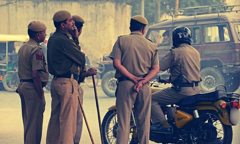 Police officers and a woman on a motorcycle in an urban setting.