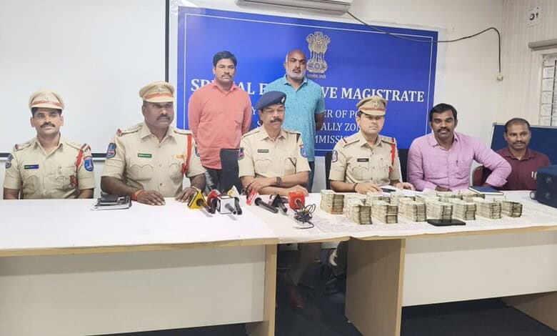 Hyderabad police arrest ATM van driver involved in Rs 56 lakh theft, with officers displaying seized cash.