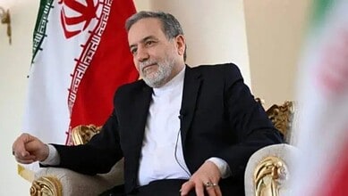 Iranian Foreign Minister during nuclear talks with US, seated in a formal setting.