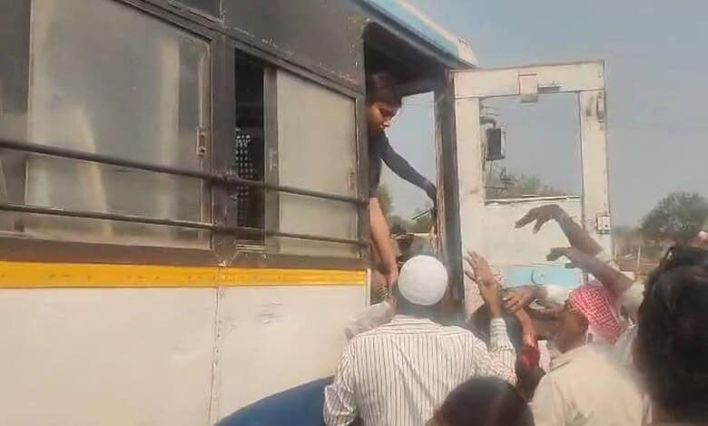 Passengers alight from a bus after an accident in Telangana