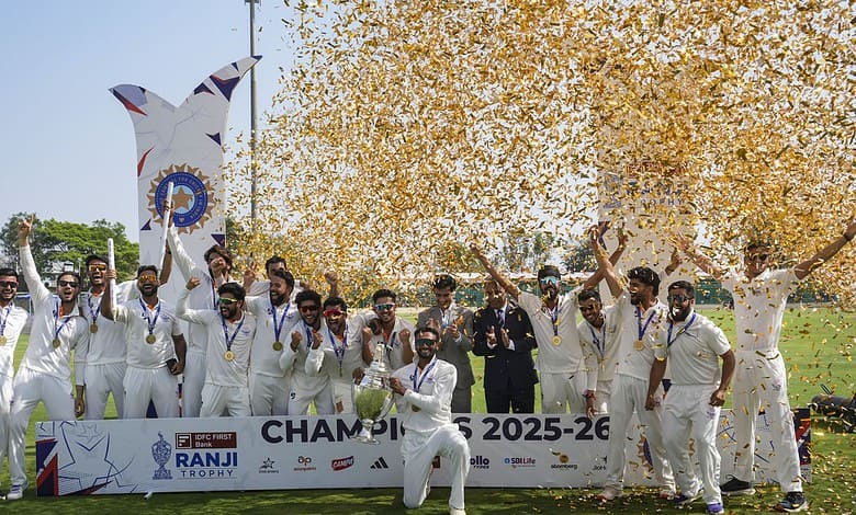 J&K cricket team celebrating their maiden Ranji Trophy victory with players holding medals and a trophy,.