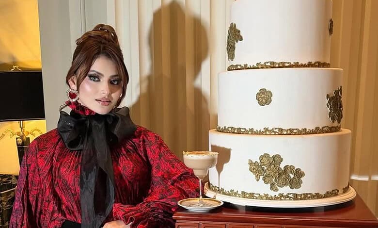 Expensive cake worth Rs 16 crore with gold accents, displayed with a woman in elegant attire.