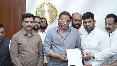 Officials review documents related to the delayed compensation process.